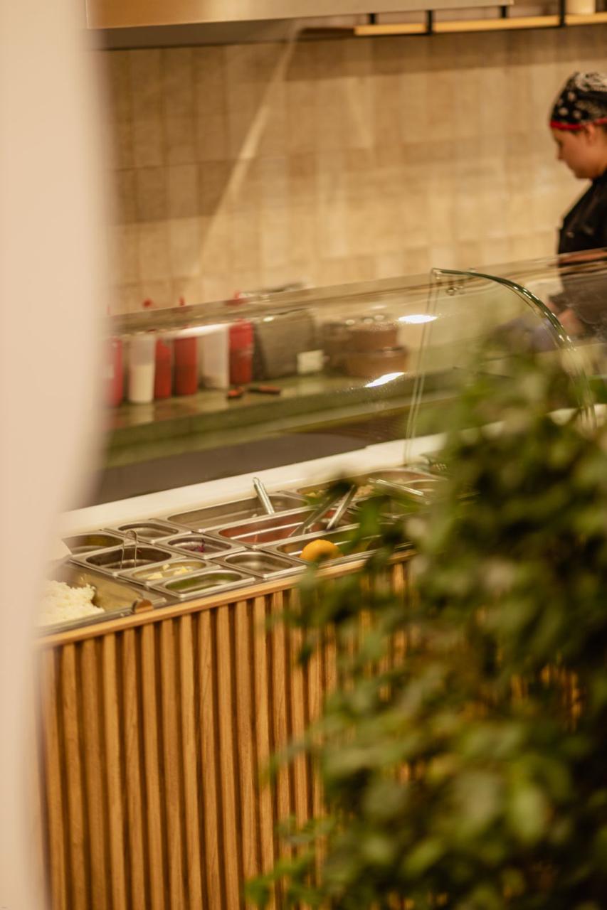A Poke Bar cook working the fresh ingredient line